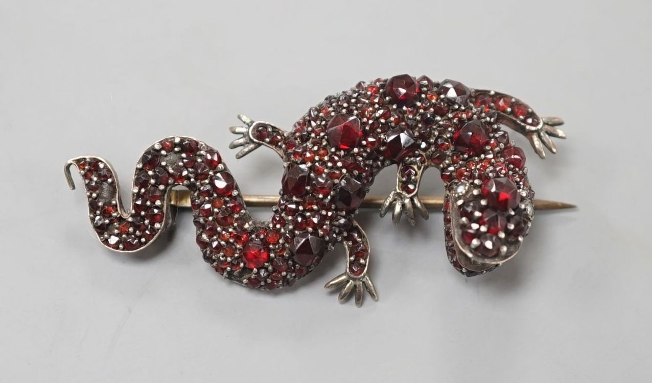 A Victorian gilt white metal and garnet cluster set lizard brooch, 49mm.
